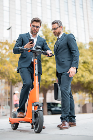 Outdoor business meeting. Business discussion. Businessman sharing his experience. Business partners meeting outdoor. Two confident business people in formalwear discussing.の写真素材