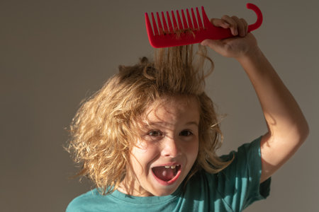Tangled kids hair. Kid brushing tangled hair. Funny kids haircut.の写真素材