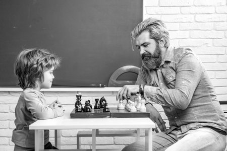 Father teaching his son to play chess. Chess strategy. Chess success and winning. Education and people concept. Happy Fathers day.の写真素材