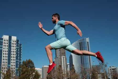 Runner man training outside. Caucasian male athlete jogging in San Diego city. Fit young jogger running.の写真素材