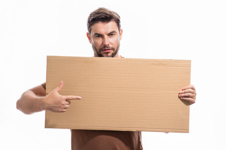 Handsome middle aged man with blank placard. Demonstrating copy space for your text or design. Man showing empty advertisement board on studio background. Blank placard, signboard for ad.の写真素材