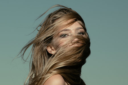 Beautiful woman with shiny hair. Beauty face of young girl. Hair on face.の写真素材