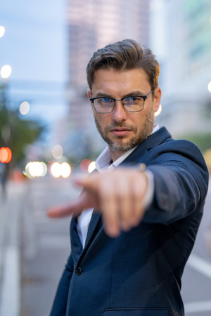 Business man goals. Success of business man point you outdoor. Hispanic businessman happy at the city. Serious businessman pointing finger on you. Portrait of businessman in suit outdoor.の写真素材