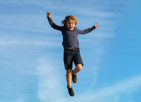 Funny kids emotions. Outdoor close up portrait of a cute little child playing outdoor. Portrait of pretty little kids face outside.の写真素材