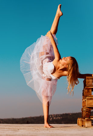Yoga woman, ballet dancer stretching with pose stretch. Fit fitness athlete girl exercising sports stretches. Ballet dancer.の写真素材