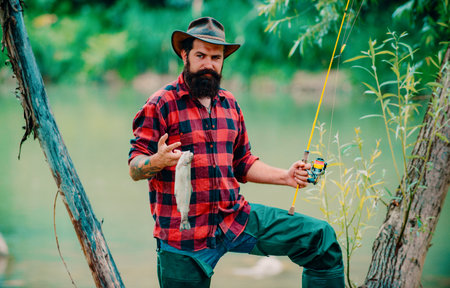 Portrait of fisher man using rod flyfishing in mountain river. A fly fisherman fishing for wild...