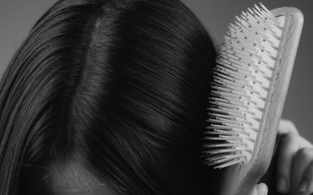 Closeup hair loss, hair fall in hairbrush, stress problem of woman with a comb.の写真素材