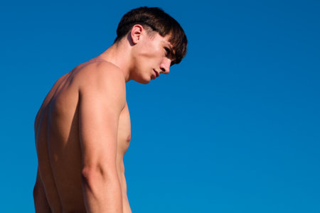 Handsome man, portrait of nude guy on sky.の写真素材