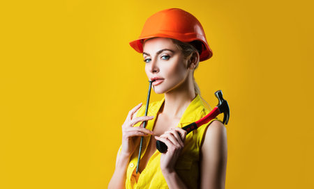 Sexy woman in helmet to use hammer. Sensual girl hammering nail. Fixed concept.