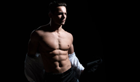 Muscular guy with sexy torso. Strong man showing his perfect naked body. Bare torso.の写真素材