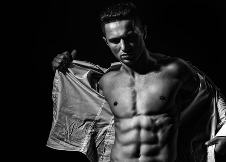 Sexy man with muscular body and bare torso. Muscular shirtless man, attractive guy. Athletic man, fitness model. Sexy torso. Male flexing his muscles. Sport workout bodybuilding.の写真素材