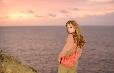 Beautiful woman on beach. Girl on sunset outdoors. Summertime. Carefree.の写真素材