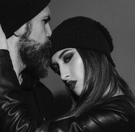 Couple in love, sensual lovers hugging and embracing. Close up fashion portrait of stylish young pretty couple in love hugs on red. Couple in love on date in formal fashion look.の写真素材