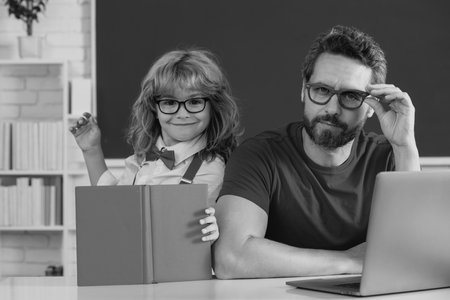 School teacher and child pupil in classroom. Funny happy elementary school boy.の写真素材