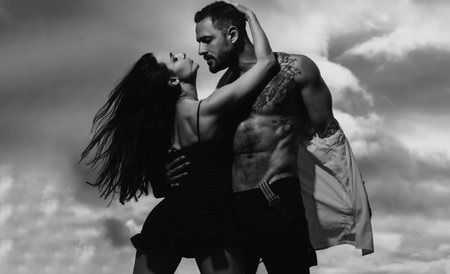 Kissing sexy couple in embrace. Couple of romantic lovers kissing and hugging. Sexy elegant lovers couple in the tender passion. Sensual brunette lady seducing her lover.の写真素材