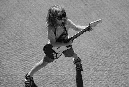 Music kids. Little boy playing guitar. Rock music, pop music. Kids music concept.の写真素材