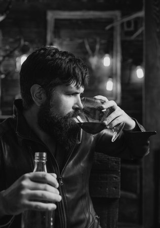 Drunk men hipster drinking alcohol feeling lonely and desperate in emotional stress. Alcohol addiction, drunk man.の写真素材