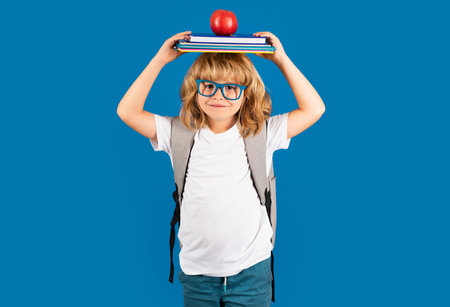 Back to school. Schoolboy with school bag hold book and copybook ready to learn. School children on...