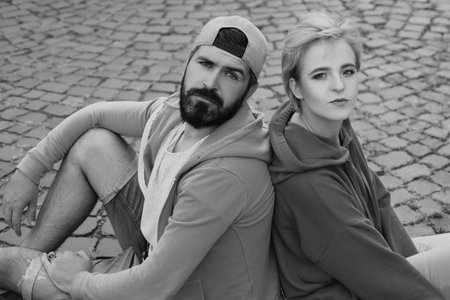 Youth fashion. Feeling free and stylish. Man and woman modern clothes for youth relaxing outdoors. Forever young. Couple hang out together. Carefree people. Youth just want have fun. Freedom feelingの写真素材