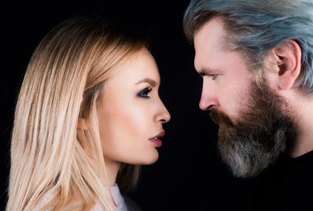Sensual portrait of young stylish fashion couple on black background.の写真素材
