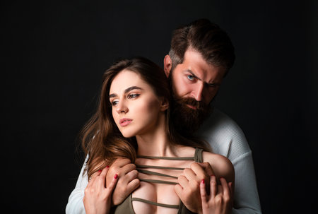 Romantic couple in love looking at each other. Sensual couple getting closer to feel each others lips. I love you. Handsome young man seducing his lovely girlfriend.の写真素材