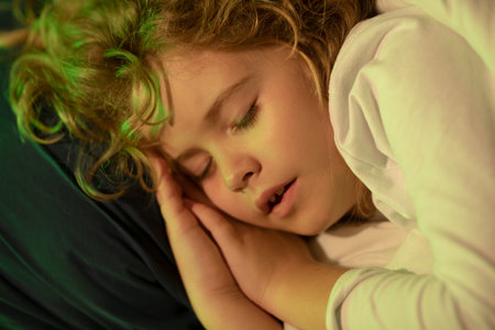 Quiet sleep. Little kid sleeps on bed, napping. Cute child sleeping.の写真素材