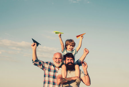 Happy child playing outdoors. Family people. Father and son playing outdoors. Male multi generation portrait. Leisure activity. Childhood concept.の写真素材