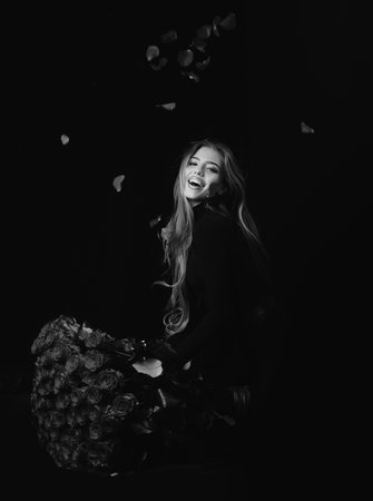 Smiling woman with Valentines day present. Sensual sexy girl with rose bouquet.の写真素材