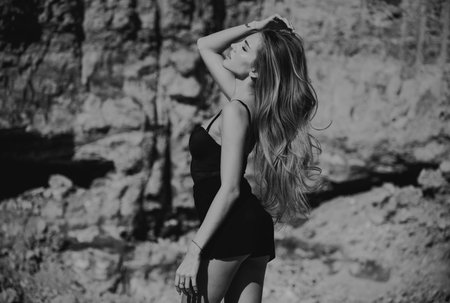 Summer fashion model. Stylish fashion woman posing outdoor. Attractive young woman in sexy dress enjoying summer.の写真素材