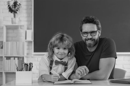 School pupil with teacher in classroom. Teacher and little student portrait, teachers day.の写真素材