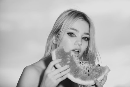 Young girl eating watermelon, summer tropical fruits. Beauty woman face.の写真素材