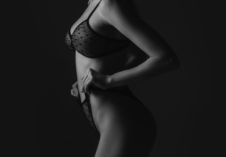 Sexy ass in erotic lingerie. Perfect Female Buttocks slim figure, bikini thong and bra underwear. Beauty butt with sensual touch.の写真素材