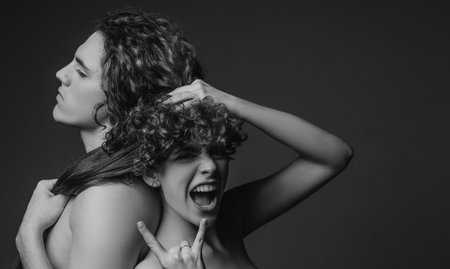 Happy to be in love. Young beautiful couple in love. Affectionate couple having a fun while a photo session. Family. Sensuality. Beautiful young smiling couple in love. Copy spase.の写真素材