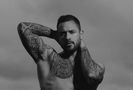 Sexy man with naked torso. Seductive face of a sexy man. Macho looking confident.の写真素材