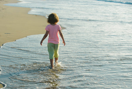 Summer kids holidays. Child playing in the sea. Kids having fun on the beach.の写真素材
