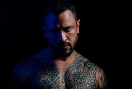 Brutal man, serious face of handsome male model, concept of men power and strong. Close up portrait of guy with serious face.の写真素材