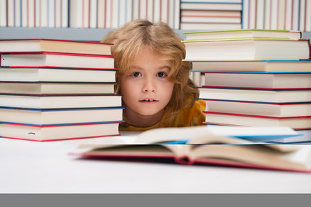 Little student read book. Child reading book in a book store or school library.の写真素材