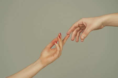 Reaching touching hands. Reach hand. Sensual touch fingers. Two hands trying to touch. Adam sign. Human relation, togetherness. Hands of man and woman reaching to each other. Hand try to touch.の写真素材