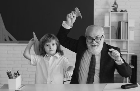 School break. Teacher with pupil with airplanes. Education, teachering, learning.の写真素材