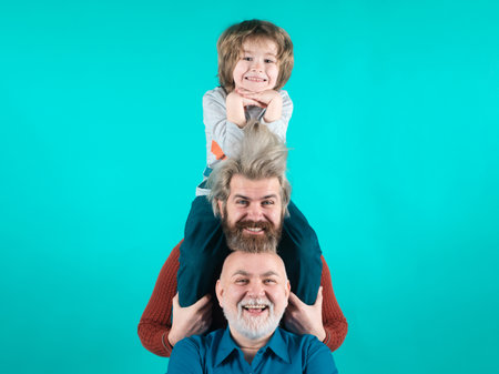 Portrait of happy grandfather father and son smilind. Fathers day concept. Man in different ages. Funny men faces.の写真素材