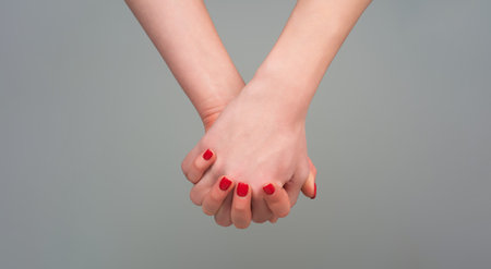 Helping hands. Holding hand, close up. Giving a helping hand. Support hand. Help hand gesture, sign of help and hope. Support arm, charity.の写真素材