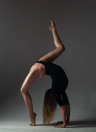 Flexible sexy girl dancing. Beautiful flexible woman body. Fashion art studio portrait of fit sexy...