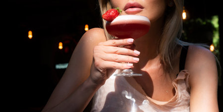 Sensual woman drinking red lip cocktail, close up. Cocktail for young. Bar and restaurant concept.の写真素材