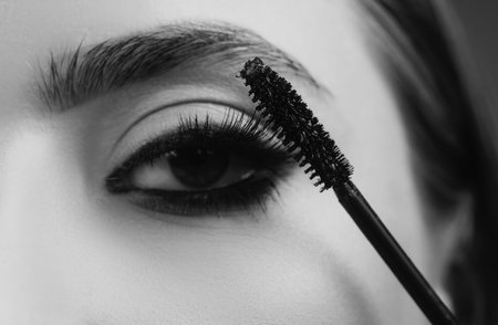 Eyebrow makeup. Beauty model shaping brows with brow pencil closeup. Beautiful woman contouring...