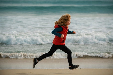 Kids running outdoors. Run and healthy sport for children. Child runner jogger running in the nature. Active healthy kids lifestyle.の写真素材