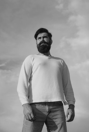 Studio shot of young man looking at the camera. Handsome guy with confident face outdoor.の写真素材