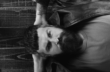 Seductive face of a sexy man. Macho looking confident. Bearded guy relaxing, dreaming. Close up portrait of guy with serious face.の写真素材