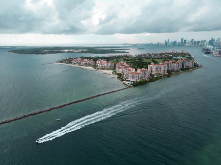 Fisher Island skyline with buildings seen from bay in South Beach. Miami Beach and Fisher Island aerial view. Luxury apartments on Fisher Island. Fisher Island from South Point Park Miami.の写真素材