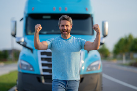 Men driver near lorry truck. Man owner truck . Serious middle aged man trucker trucking owner. Transportation industry vehicles. Handsome man driver front of truck.の写真素材