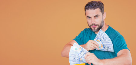 Successful man counting money. Handsome middle age man holding bunch of 100 dollar banknotes. Guy holding money cash. Business man with dollar cash.の写真素材